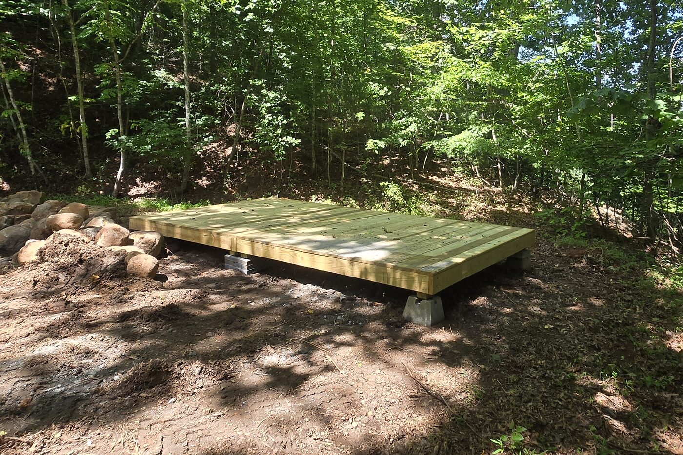 The two tent decks at Rockies 7, Cardinal Mountain Campground, with a rock border along one edge