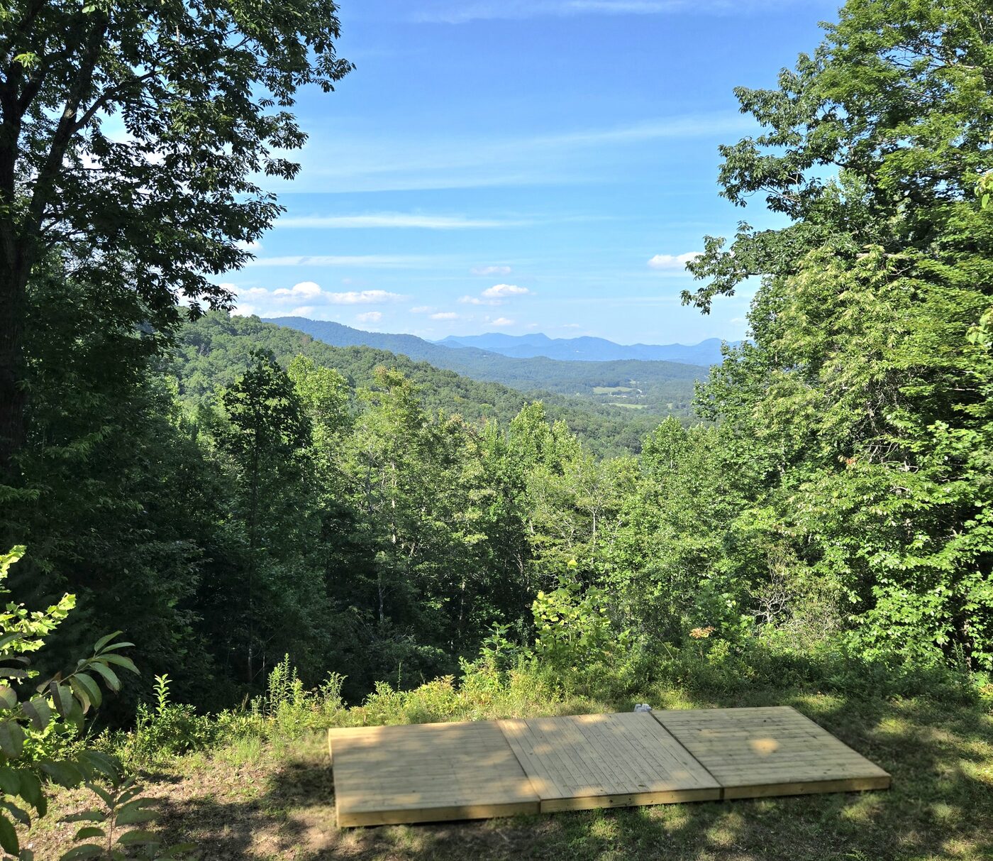 The long tent deck at Arches 13, Cardinal Mountain Campground, with the open view north over the ridges