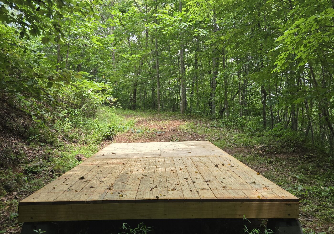 The two side-by-side decks at Acadia 15, Cardinal Mountain Campground, with the path running back behind