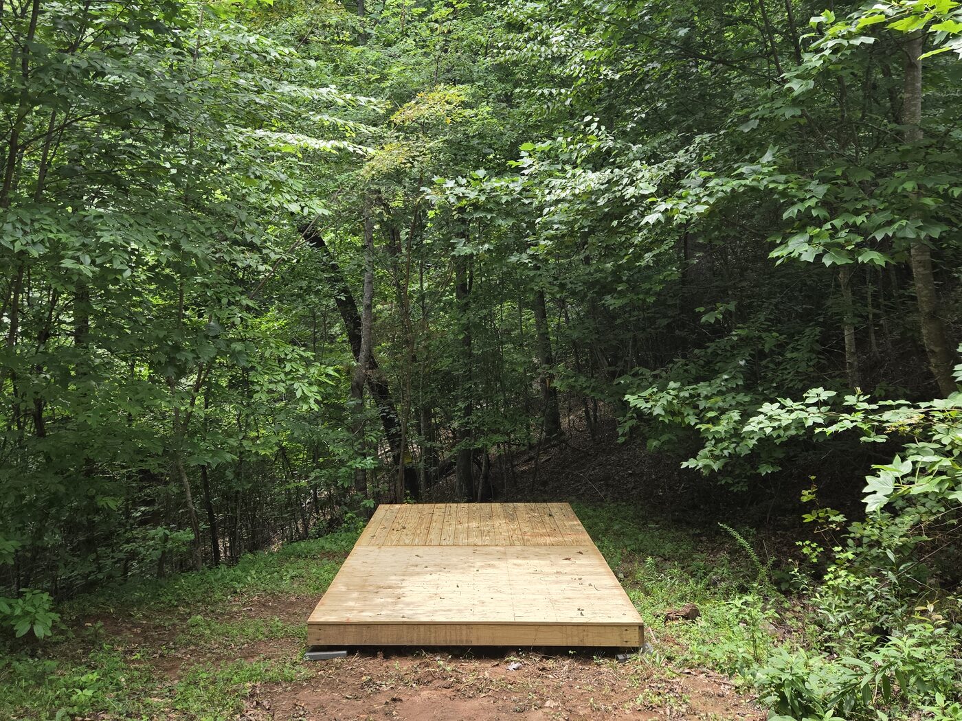 The decks at Acadia 15, Cardinal Mountain Campground, screened by green on every side