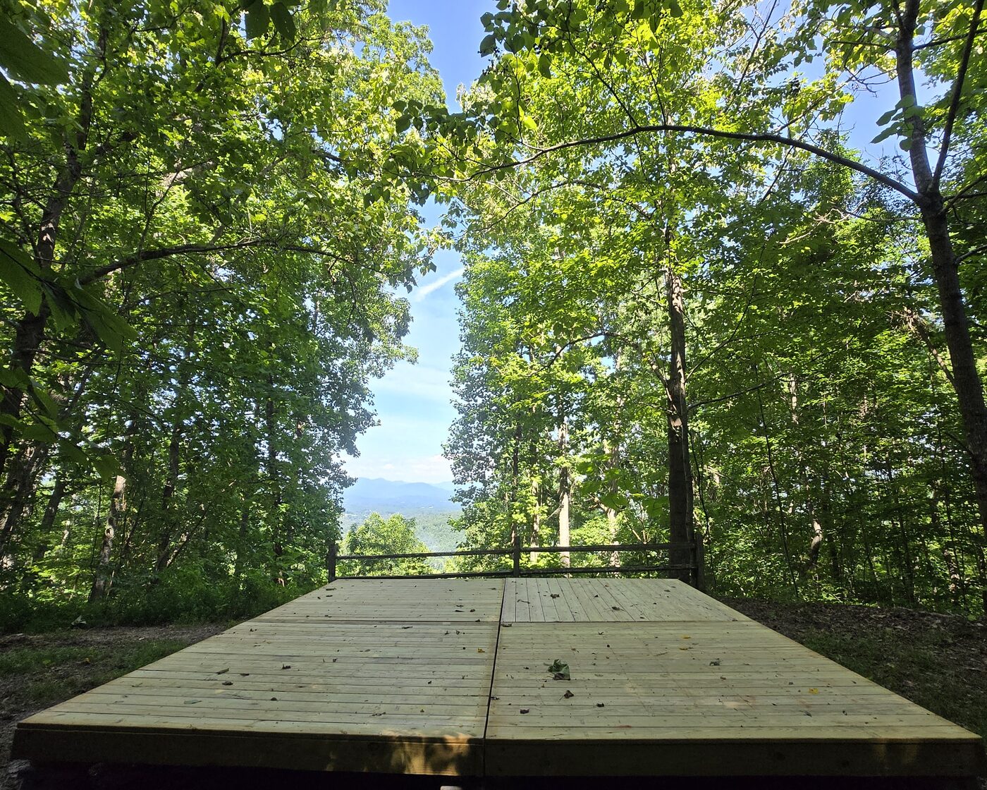The tent deck at Smokies 17, Cardinal Mountain Campground, looking east through the trees to the ridgeline