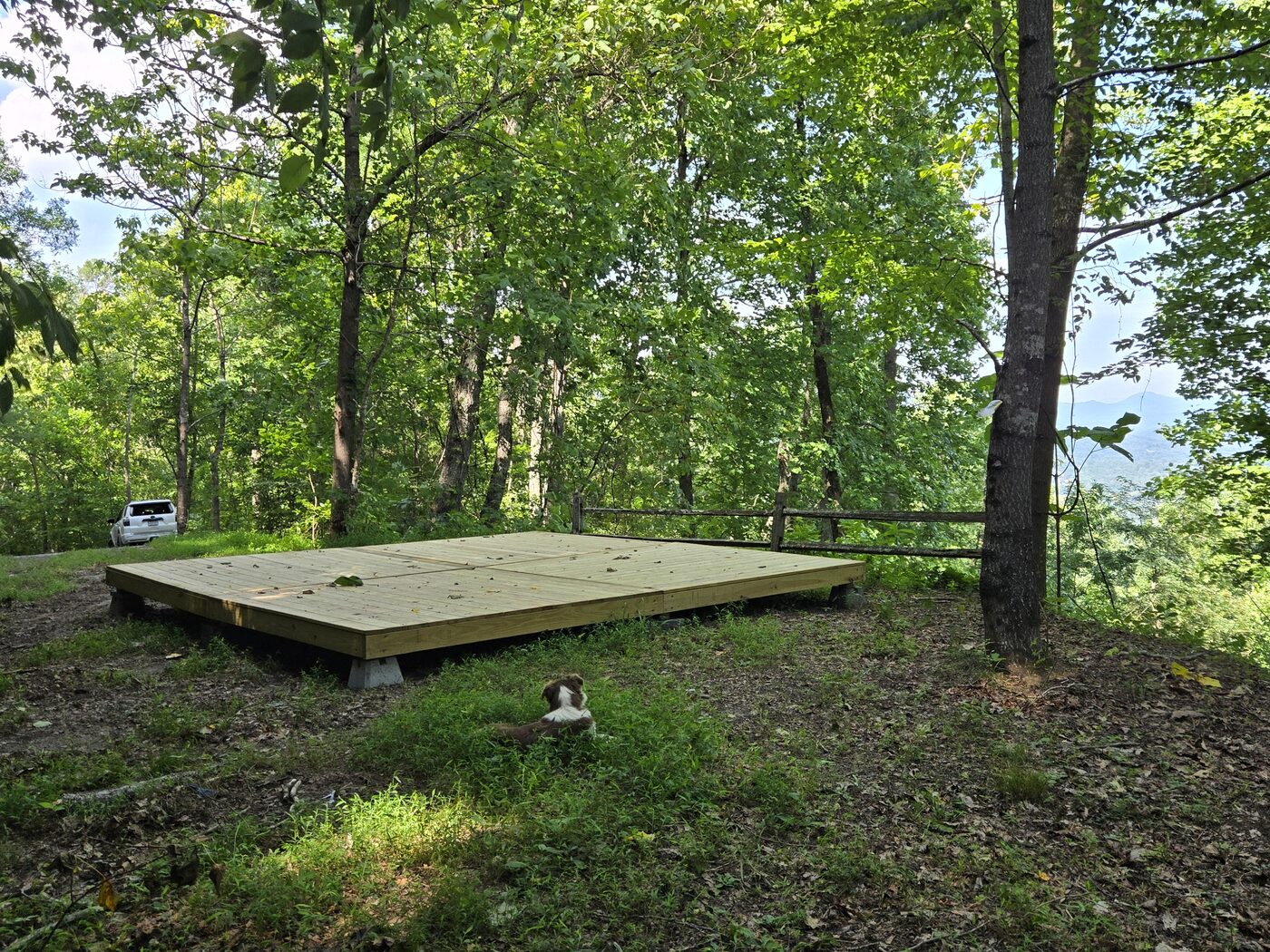 The site at Smokies 17, Cardinal Mountain Campground, with a split-rail fence along the downhill edge
